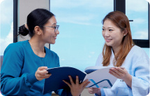 women reading report with nurse