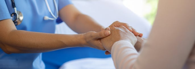 醫生以慈悲之心握著病患的手