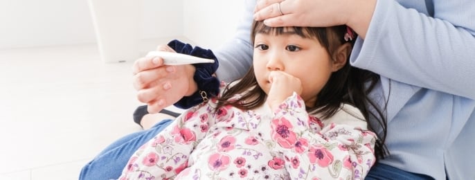Mother Checking Temperature of Sick Child