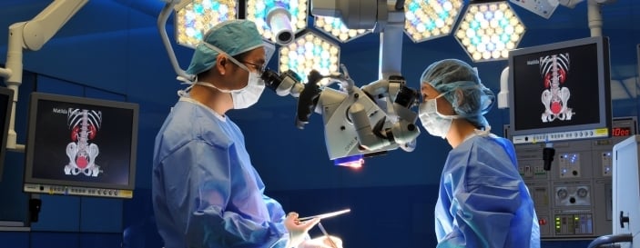 Medical team performing surgery in an operating theatre.