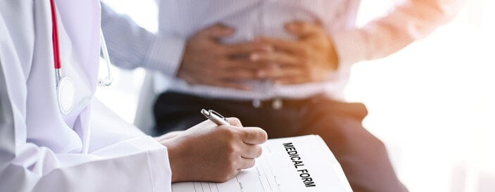 Close up doctor takes a history of gastroenteritis, stomach ache patients