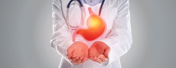 Treatment of Gastrointestinal Diseases. Doctor Holding Stomach.