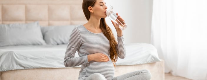 Expecting mother drinking water during pregnancy