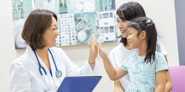 doctor high fiving child