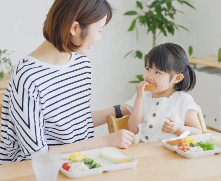 mother and daughter eating