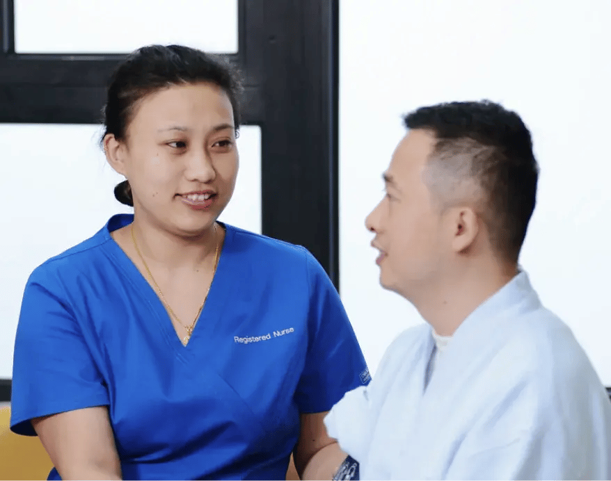 female nurse and a male patient inside a doctors room