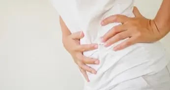 women holding stomach