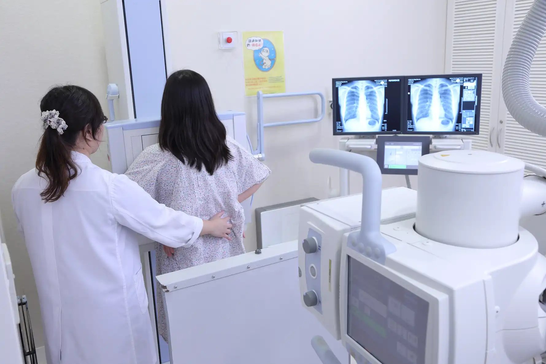 female patient taking chest xray