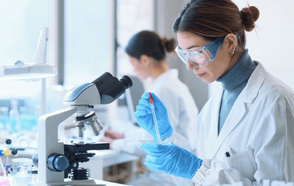 woman in lab with microscope