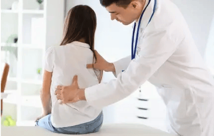 doctor adjusting child's back