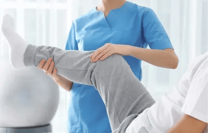 nurse adjusting patient's knee