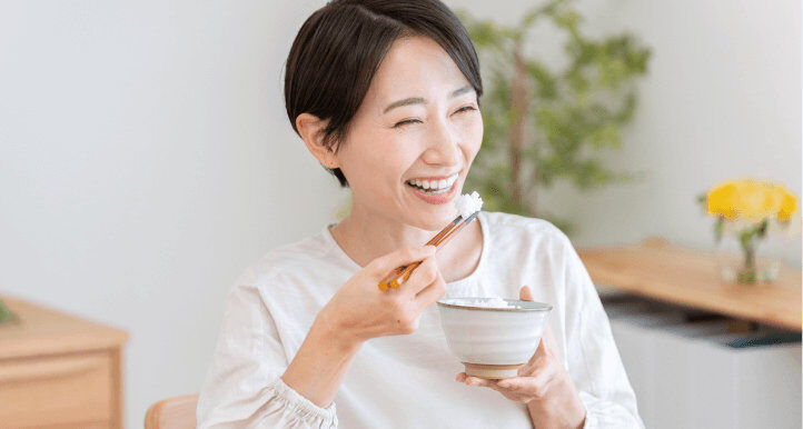 happy asian lady eating rice