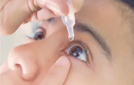 person putting in eye drops
