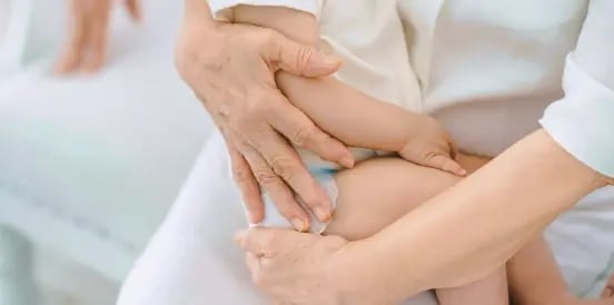 baby being held and carried