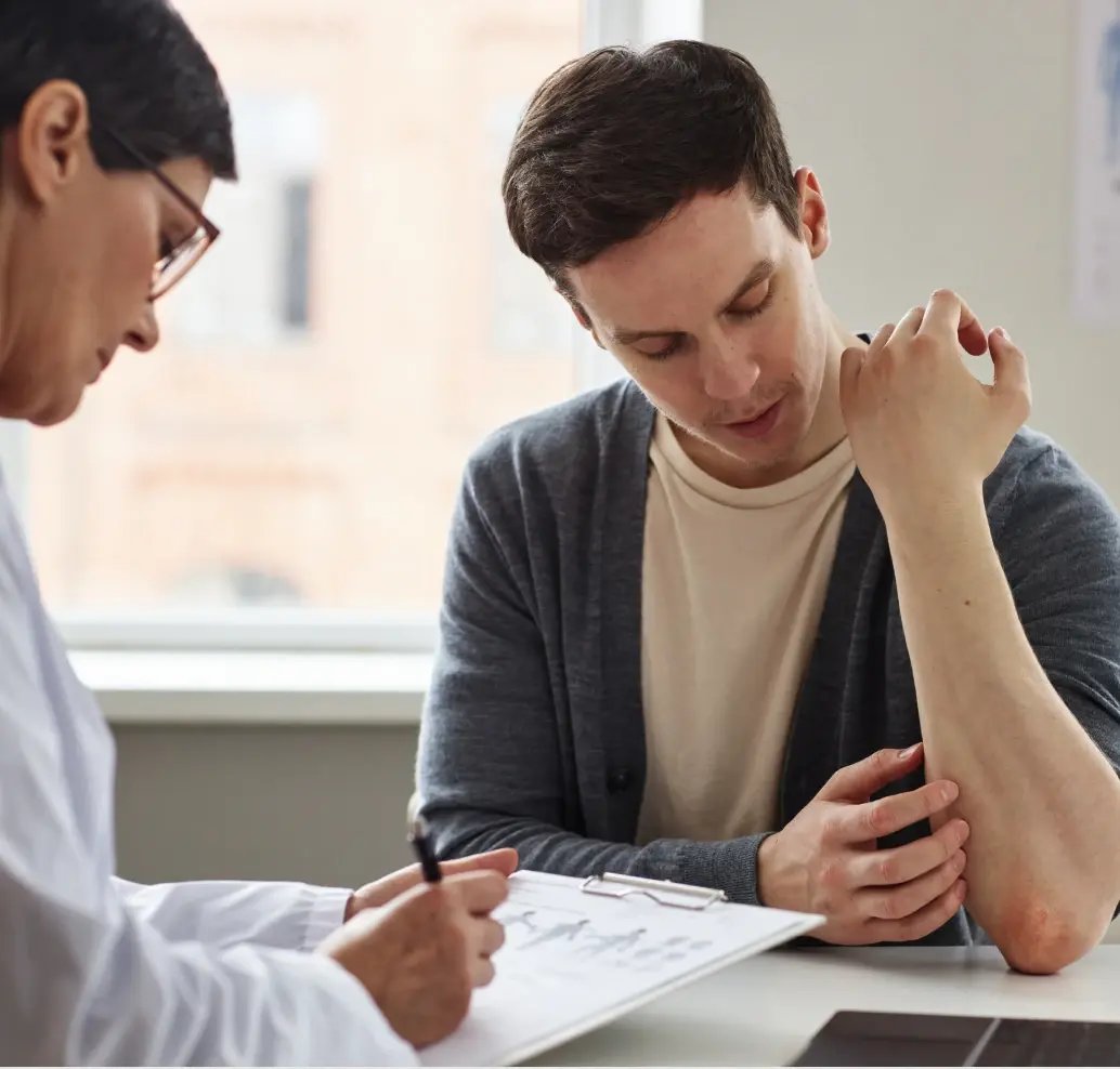 man speaking to doctor about skin